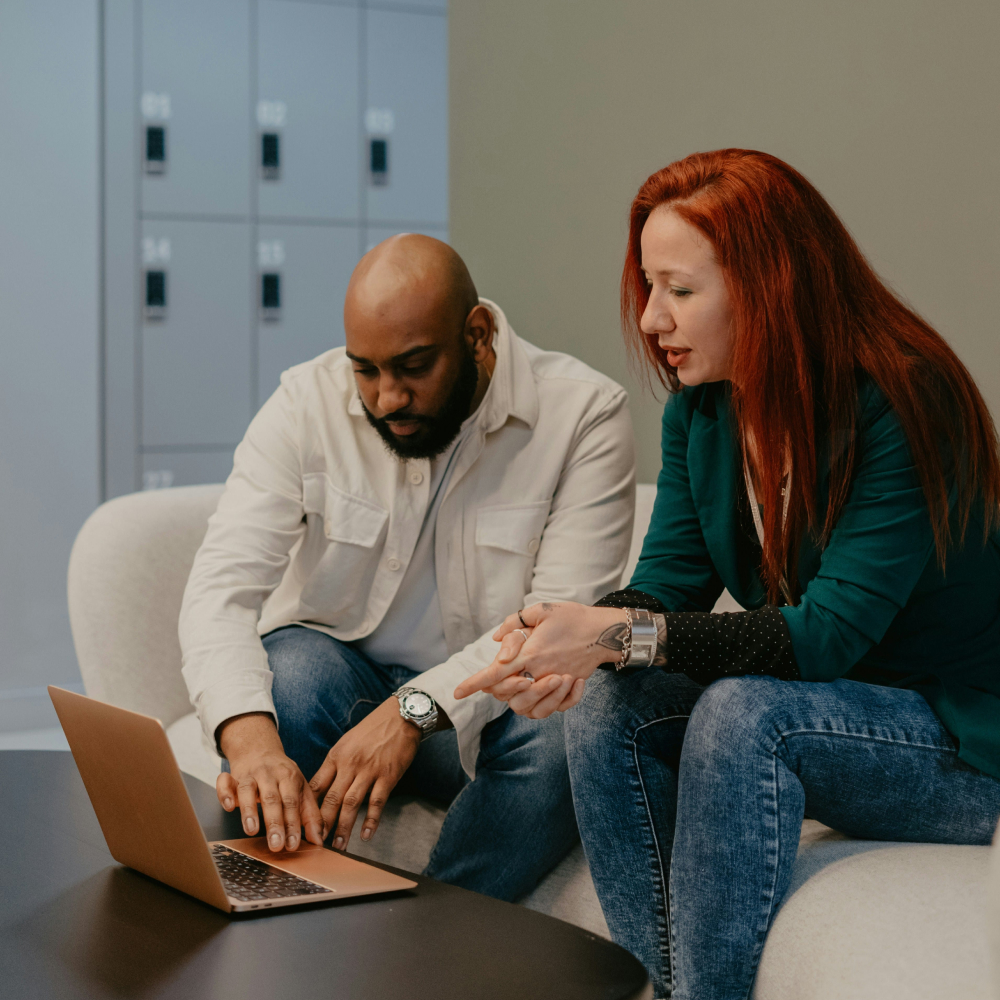 man and woman looking at laptop