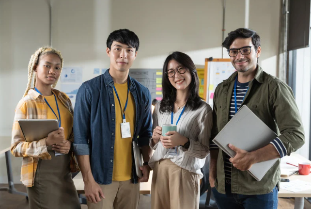 Four employees smiling