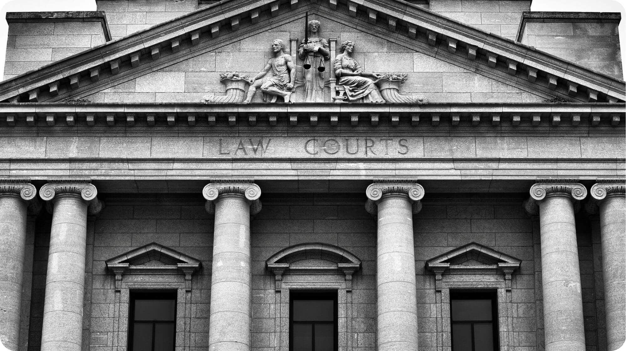 The stone block facade of a law court.