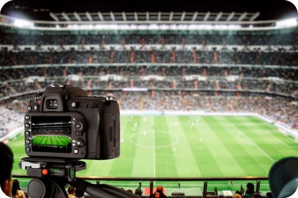 A digital camera screen showing a sports stadium through the viewscreen.