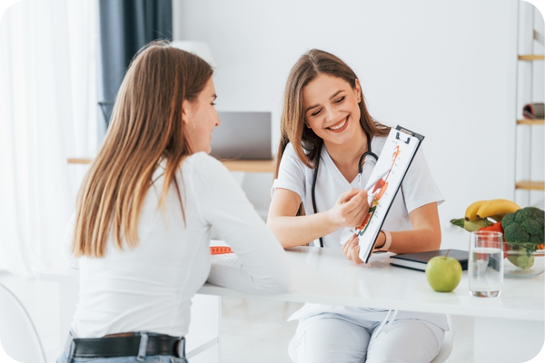 A nutritionist is showing a diagram of the internal organs to a client.